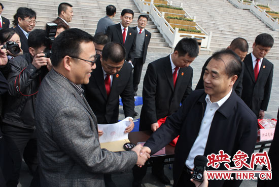 在新密市法院，省高院院長張立勇為拍得轎車的陳先生發(fā)放車鑰匙。