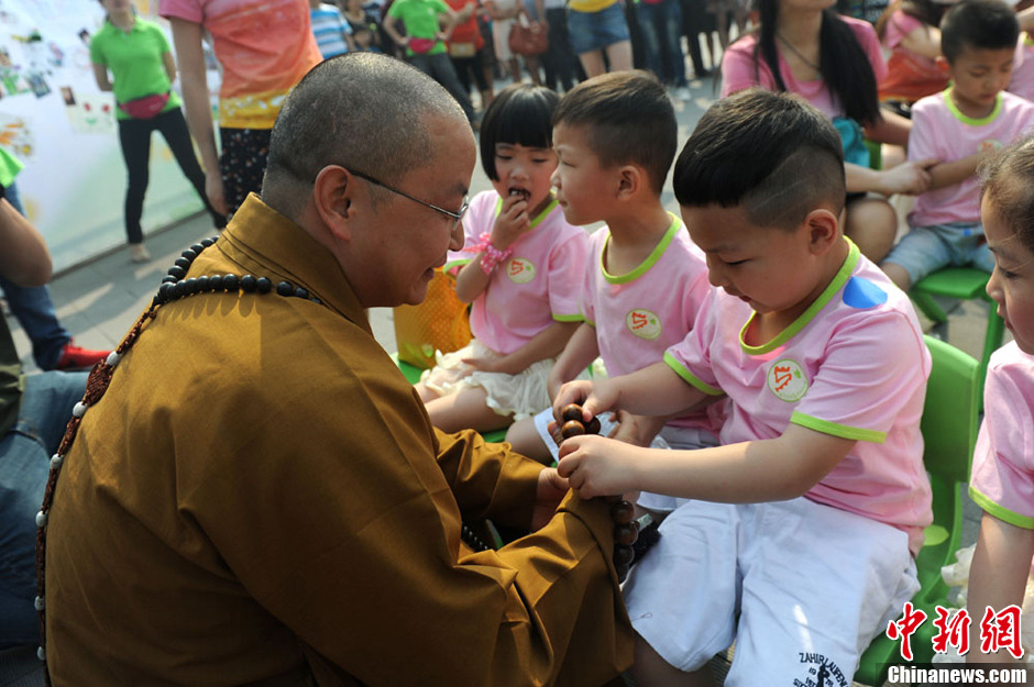 圖為羅漢寺素全法師與參加生日party的孩子。張浪 攝