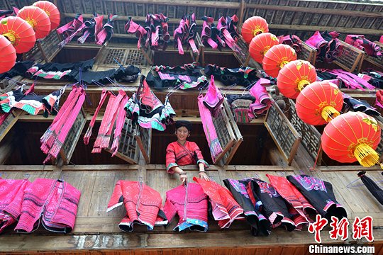 圖為紅瑤姑娘把紅衣晾曬出來。中新社發(fā) 韋吉陽 攝