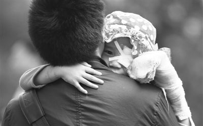 昨日，北京同仁醫(yī)院，被砍傷的彤彤趴在舅舅的肩上。他們剛剛掛完號，正準(zhǔn)備回旅館。新京報記者 尹亞飛 攝