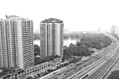 昨日，人濟山莊小區(qū)，與其他樓相比，B棟樓頂層天臺上違規(guī)建造了一棟兩層小樓，假山大樹俱全。新京報記者