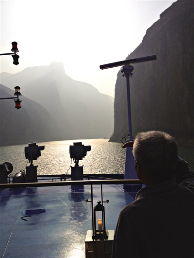 　　游客在游輪上遠(yuǎn)眺三峽風(fēng)光。