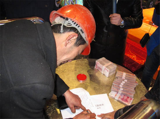 農(nóng)民工在現(xiàn)場領(lǐng)取工資。