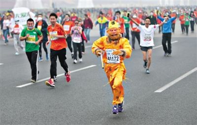 長安街，一名打扮成孫悟空的參賽者在北馬隊(duì)伍里飛奔。 本版攝影/新京報(bào)記者 吳江 李飛 王嘉寧 吳江