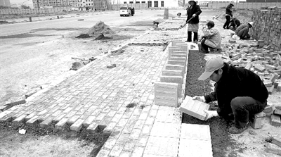 端午路正在鋪設(shè)人行道道磚，進(jìn)行工程收尾。