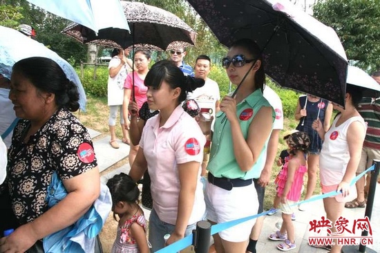 佩戴信息廣播臂貼的聽眾們在排隊等候坐帆船。